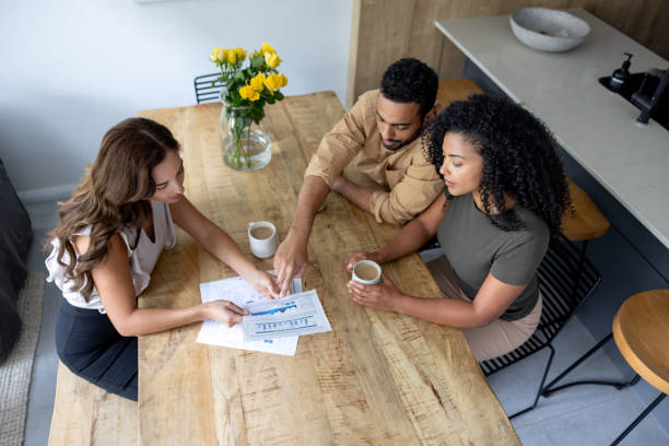 Financial advisor talking to a couple about their home finances