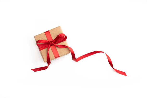istock Present or gift box wrapped in brown craft paper and red ribbon on white background 2188950129