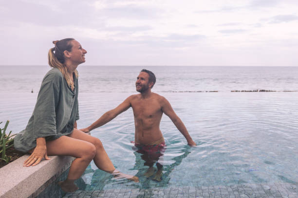 istock Couple Relaxing in Infinity Pool by the Ocean 2188951127
