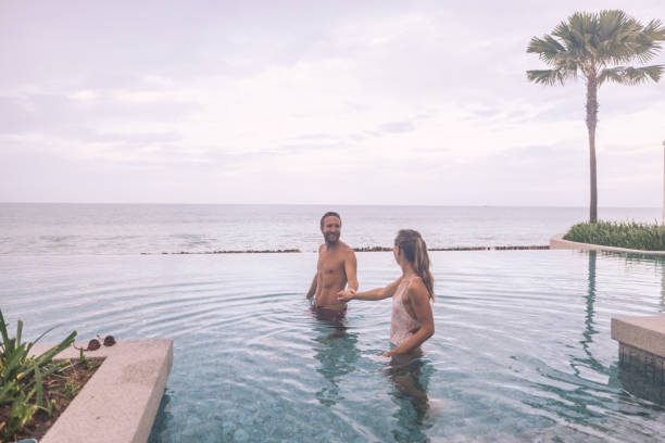 istock Couple Enjoying Leisure Time in Infinity Pool by the Ocean 2188951144