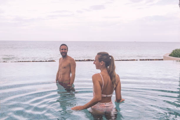istock Couple Enjoying Leisure Time in Infinity Pool by the Ocean 2188951146