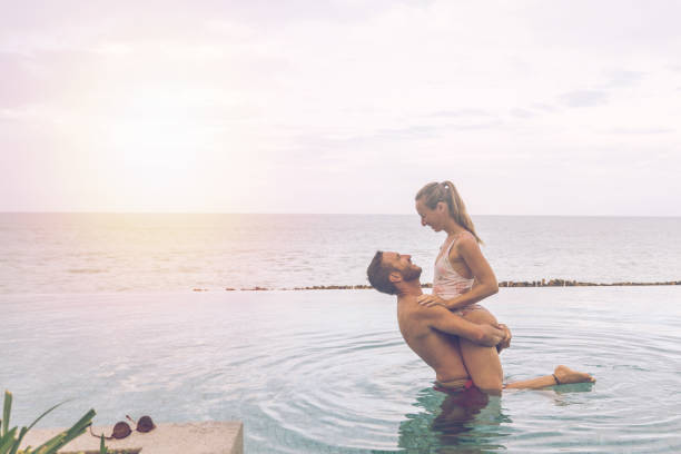 istock Romantic Couple in Infinity Pool at Sunset 2188951166