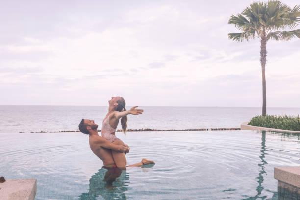 istock Romantic Couple in Infinity Pool at Sunset 2188951173