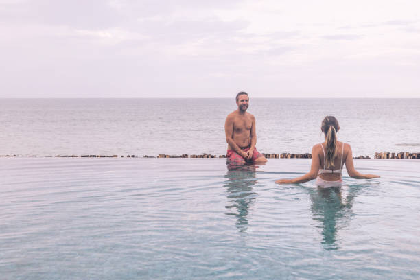 istock Couple Enjoying Relaxing Pool Day at Oceanside Infinity Pool 2188951693