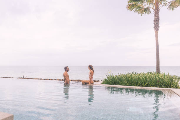 istock Couple Relaxing by Infinity Pool with Ocean View 2188951762