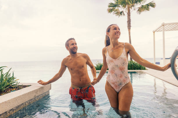 istock Couple Enjoying Poolside Retreat by the Ocean 2188951828