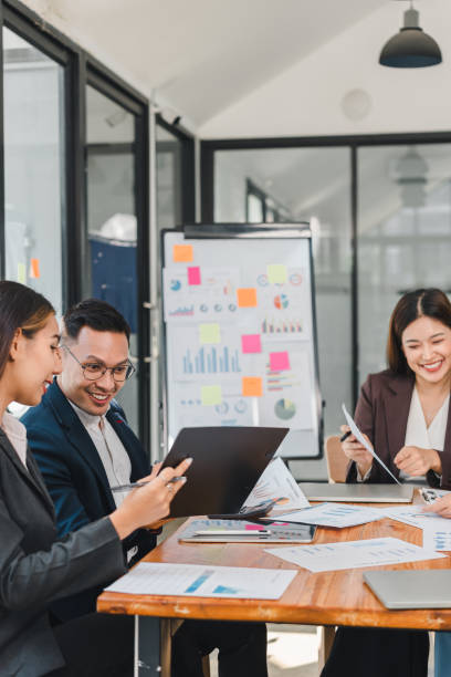 istock Efficient business meeting with professionals discussing data and strategies. Engaged team members collaborate using laptops and documents, showcasing teamwork and productivity 2188951948