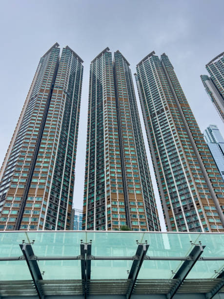 istock Tall skyscrapers under cloudy sky with modern walkway in foreground 2188953484