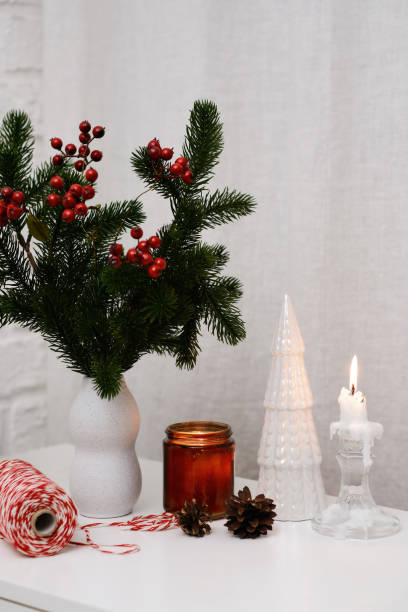 istock Cozy Holiday Decor featuring Pine and Berries , burning candle for Capturing the True Winter Vibes 2188964337