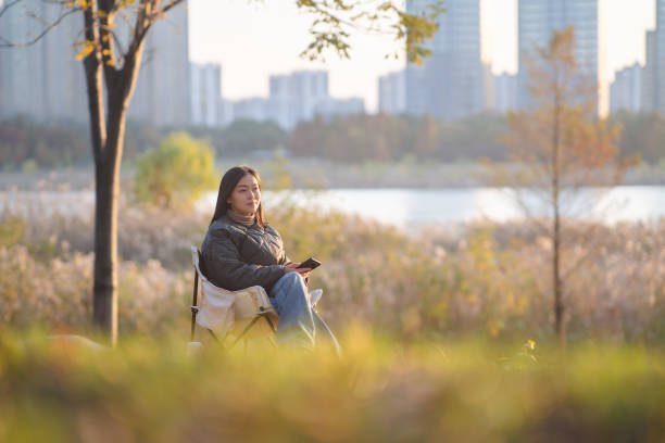 asian female using smart phone outdoor when camping