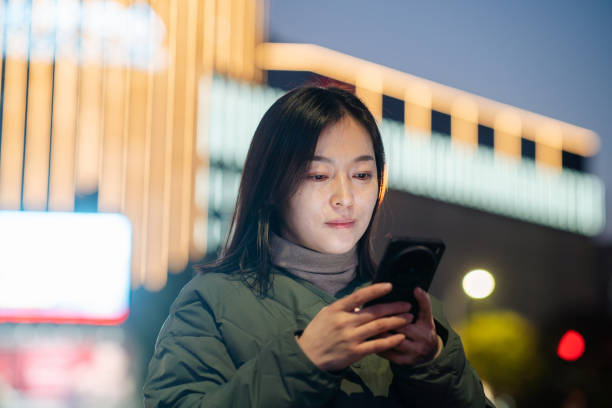 istock asian female using smart phone at night 2188965336