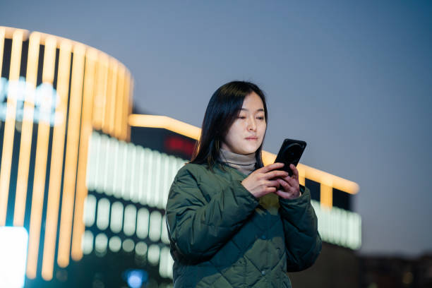 istock asian female using smart phone at night 2188965554