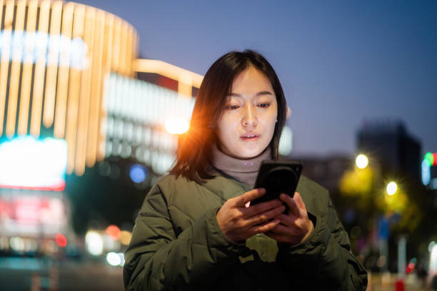 istock asian female using smart phone at night 2188966065