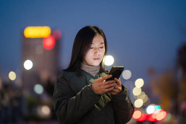 istock asian female using smart phone at night 2188966219