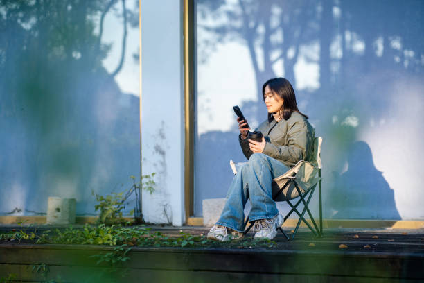 istock asian female using smart phone outdoor 2188966501