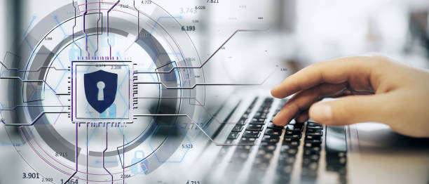 istock Digital shield icon overlaid on abstract network with a hand typing on laptop keyboard, symbolizing cybersecurity and data protection. 2188968461