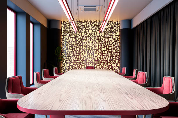 Modern boardroom interior with wooden table, stylish red chairs, decorative wall panel, and large windows creating a luxurious ambiance. 3D Rendering