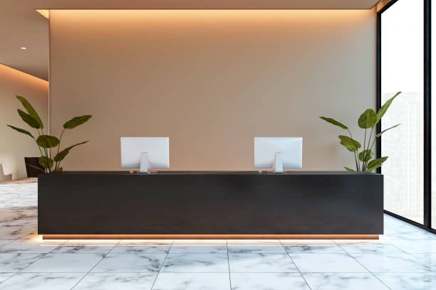 istock Modern reception desk in a contemporary office lobby with black counter, plants, and backlit lighting on marble flooring. 3D Rendering 2188969075