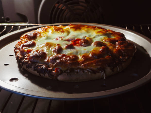 istock Delicious homemade pizza with extra mozzarella inside oven cooking view 2188970031