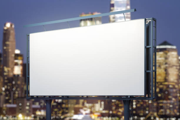 istock Blank white billboard on cityscape background at evening, perspective view. Mock up, advertising concept 2188972012