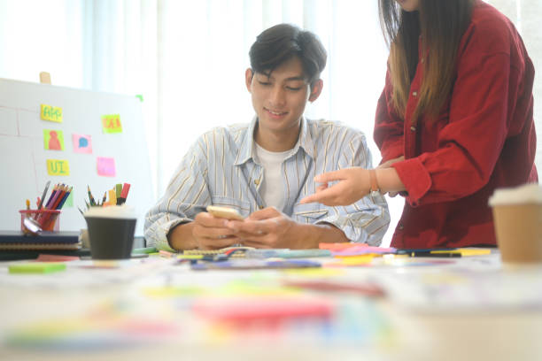 istock Close up of designers discussing app layout and interface wireframes during a brainstorming session 2188972031