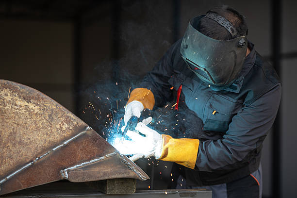 istock Professional welder joining metal parts using arc welding technique 2188972076