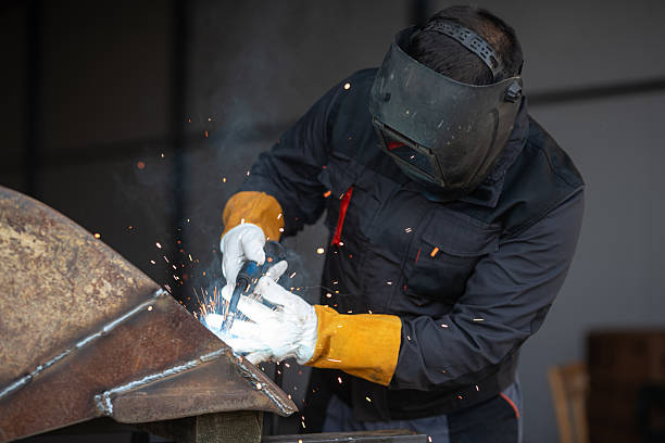 istock Industrial worker welding metal in workshop wearing protective gear 2188972120