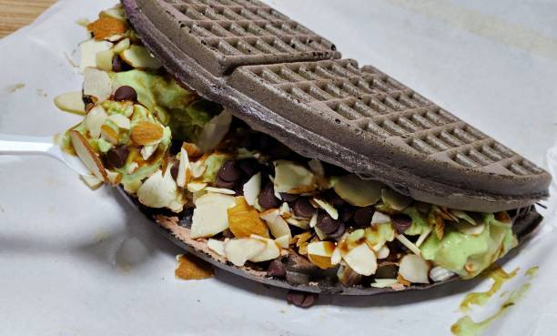 Crispy, golden waffles topped with creamy ice cream, creating a perfect balance of warm and cold, crunchy and smooth. A delightful dessert or breakfast treat, made even better with toppings like fruits or syrup.