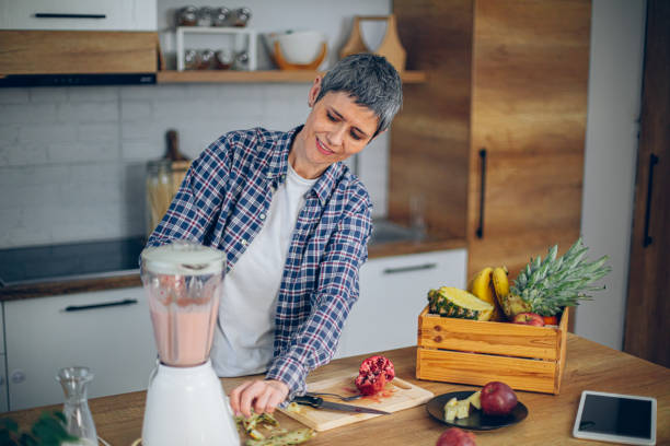 istock Woman uses a blender in the kitchen and makes a smoothie 2188973329