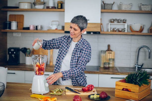 istock Woman uses a blender in the kitchen and makes a smoothie 2188973397
