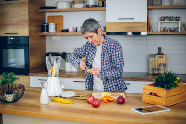 istock Middle woman making healthy smoothie in the kitchen 2188973554
