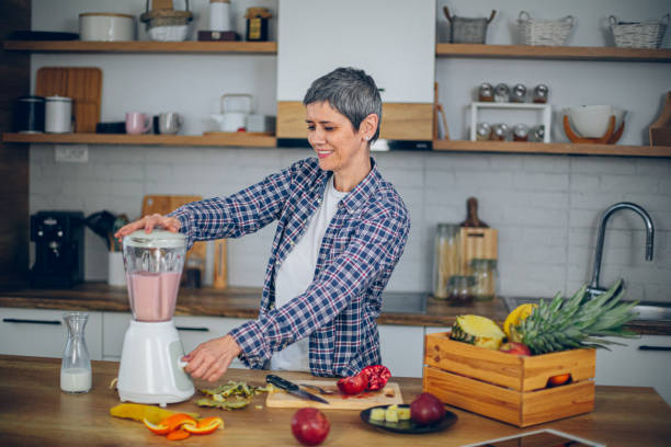 istock Woman uses a blender in the kitchen and makes a smoothie 2188973560