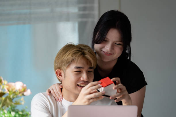 istock Young Couple Exploring Real Estate Options Online in a Modern Home Setting 2188973957