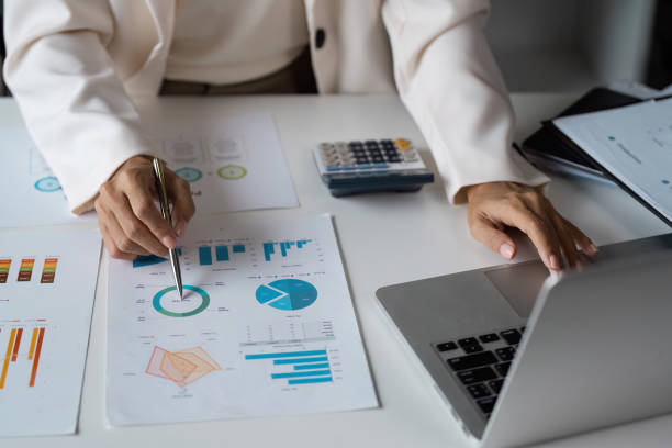 istock Professional Business Analysis with Graphs and Charts on Office Desk Featuring Laptop and Calculator 2188974382