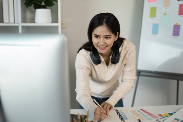 istock Creative Graphic Designer at Work with Color Swatches and Computer in Modern Office Environment 2188974688
