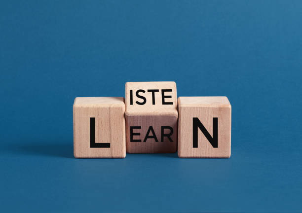 istock Listen and learn concept with wooden cubes on blue background 2188974861