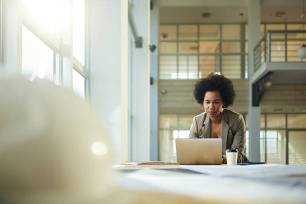 istock Black female architect working on laptop in the building. 2188976909