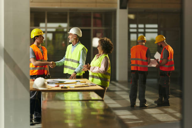 istock Happy project manager greeting a construction worker in the building. 2188977162