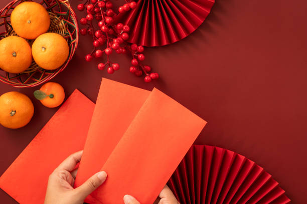 istock Chinese lunar new year background with fresh tangerine and red envelope. 2188977348