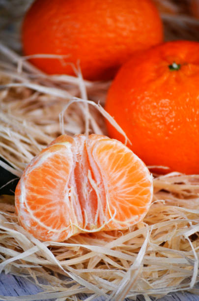 istock fresh mandarins with leafs on white wooden table 2188977562