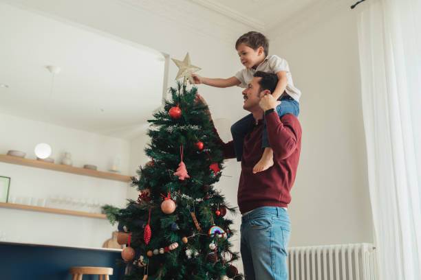 istock Happy Family Decorating Christmas Tree 2188977799