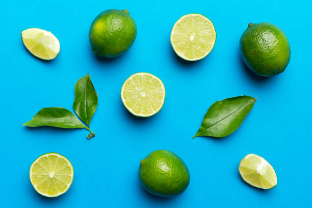 istock Lime fruits with green leaf and cut in half slice isolated on white background. Top view. Flat lay with copy space 2188978771