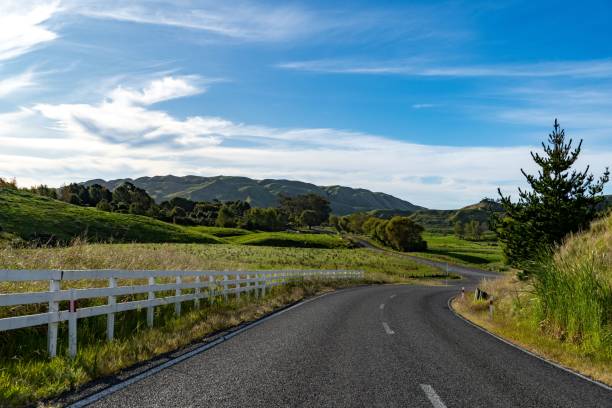 istock Scenic rural road through lush hills. 2188979328