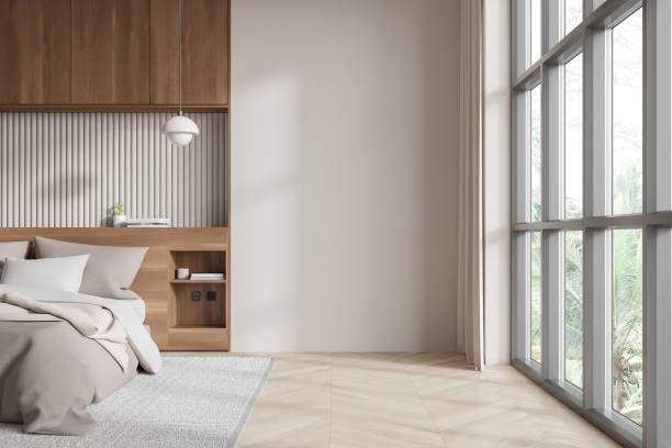 istock Minimalist bedroom with an empty wall and large windows. 3D Rendering 2188980124