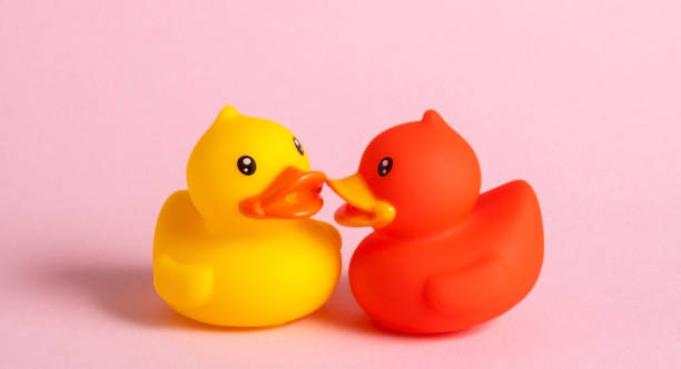 istock Two ducks kiss on pink background. 2188981694