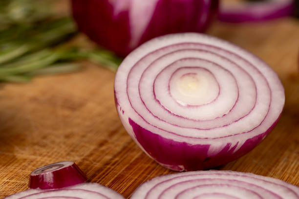 red onions on a chopping board, preparing red onions for cooking in dishes