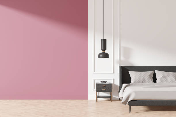istock Colored home bedroom interior with bed, nightstand with books and mock up wall 2188982965
