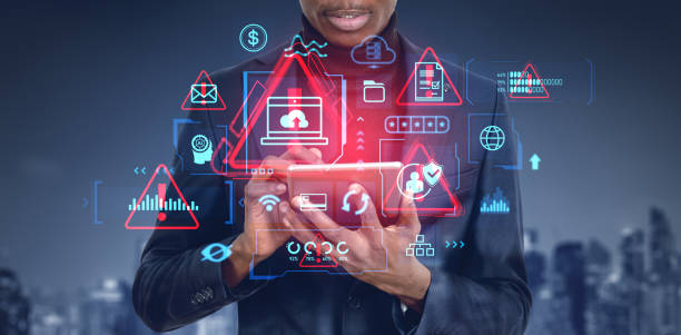 istock African man working with tablet, system alert hologram with diverse icons 2188982998