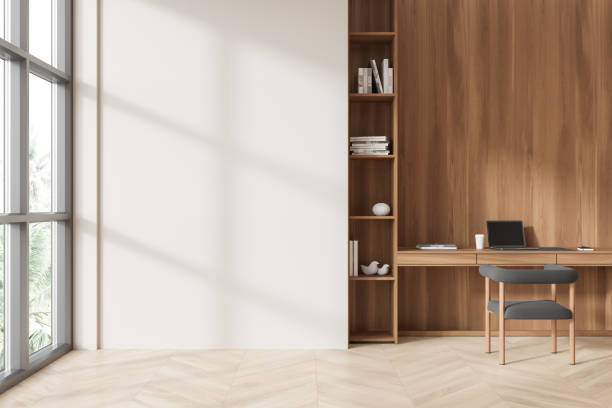 istock Minimalist office workspace with a blank wall and wooden desk area. 3D Rendering 2188983520