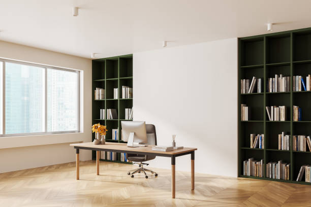 istock A modern office interior featuring a desk with a computer, bookshelves filled with books, and a large window. Bright and clean look. Concept of workspace. 3D Rendering 2188983530
